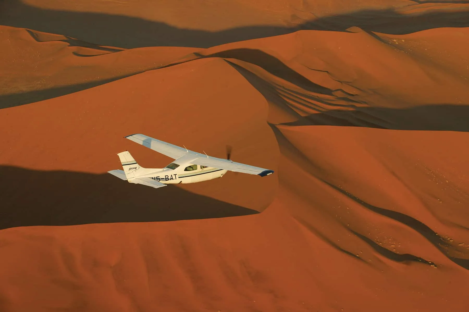 Plane flying over the dunes