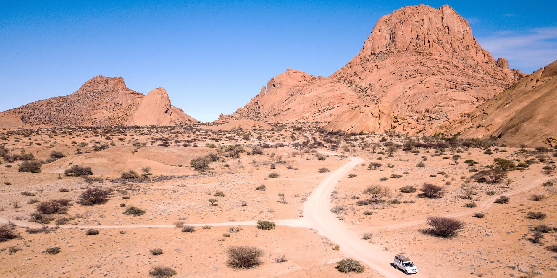 Rock formations beside a Namibian gravel road, typical scenery on a self-drive route