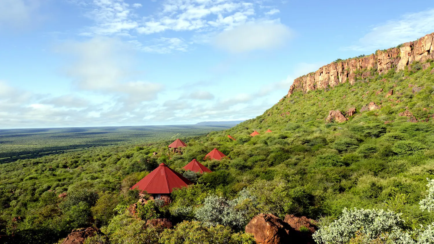 Glass-fronted chalets facing a mountain view in Namibia