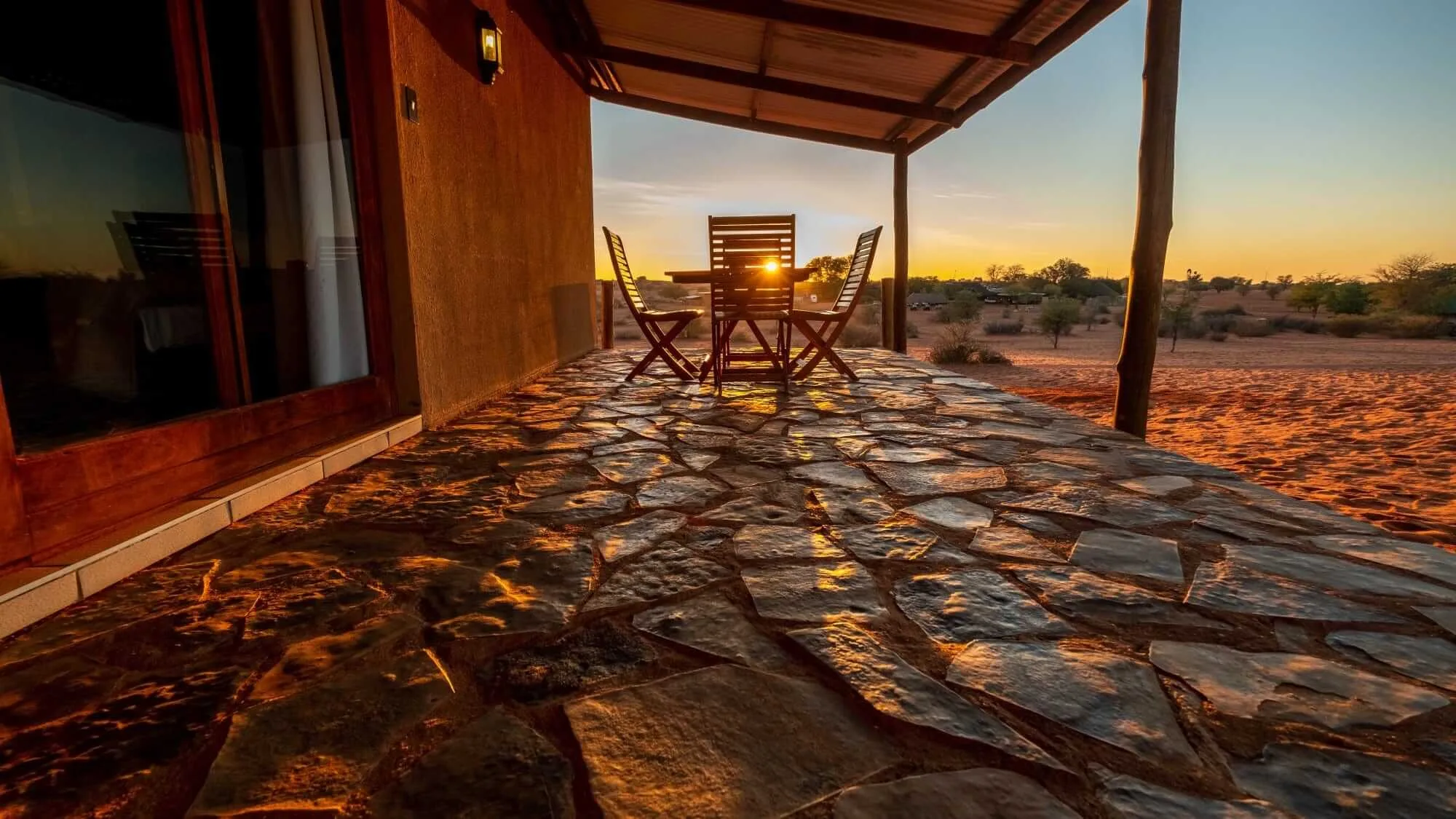 bagatelle lodge kalahari game ranch namibia guest room terrace at sunset